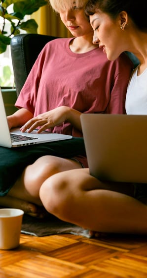 Women using laptops and sitting