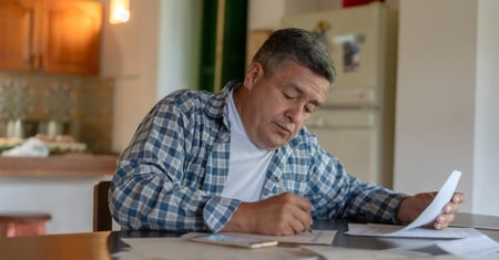 latino man writing at table