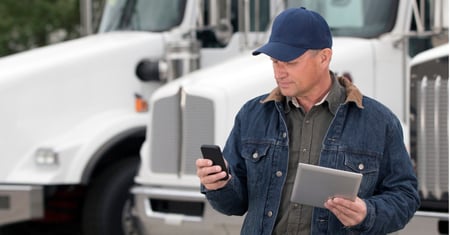 truck driver with cell phone and tablet