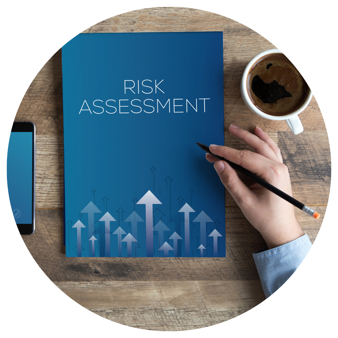 Risk assessment book on table with hand and coffee cup