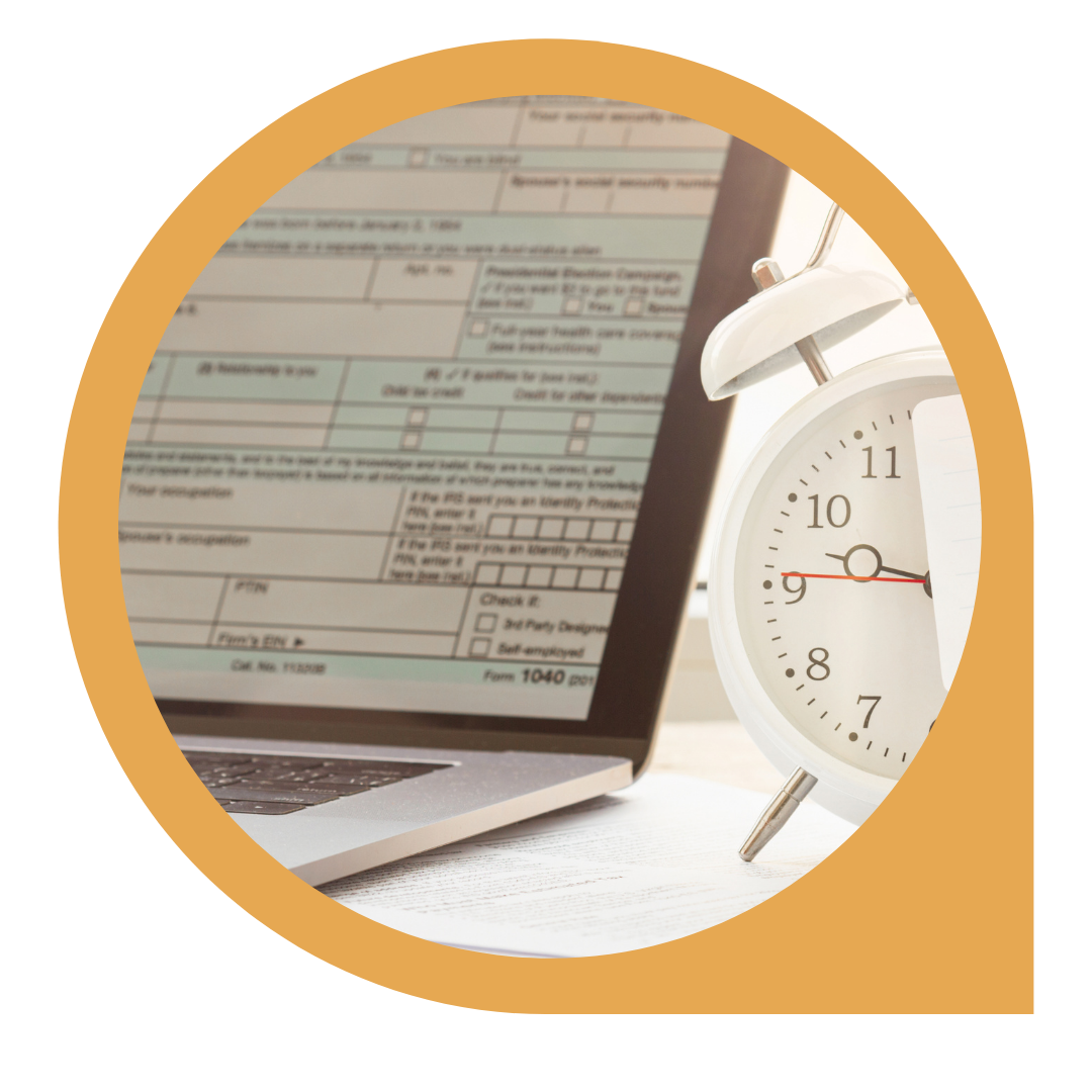 tax form on laptop screen with alarm clock 