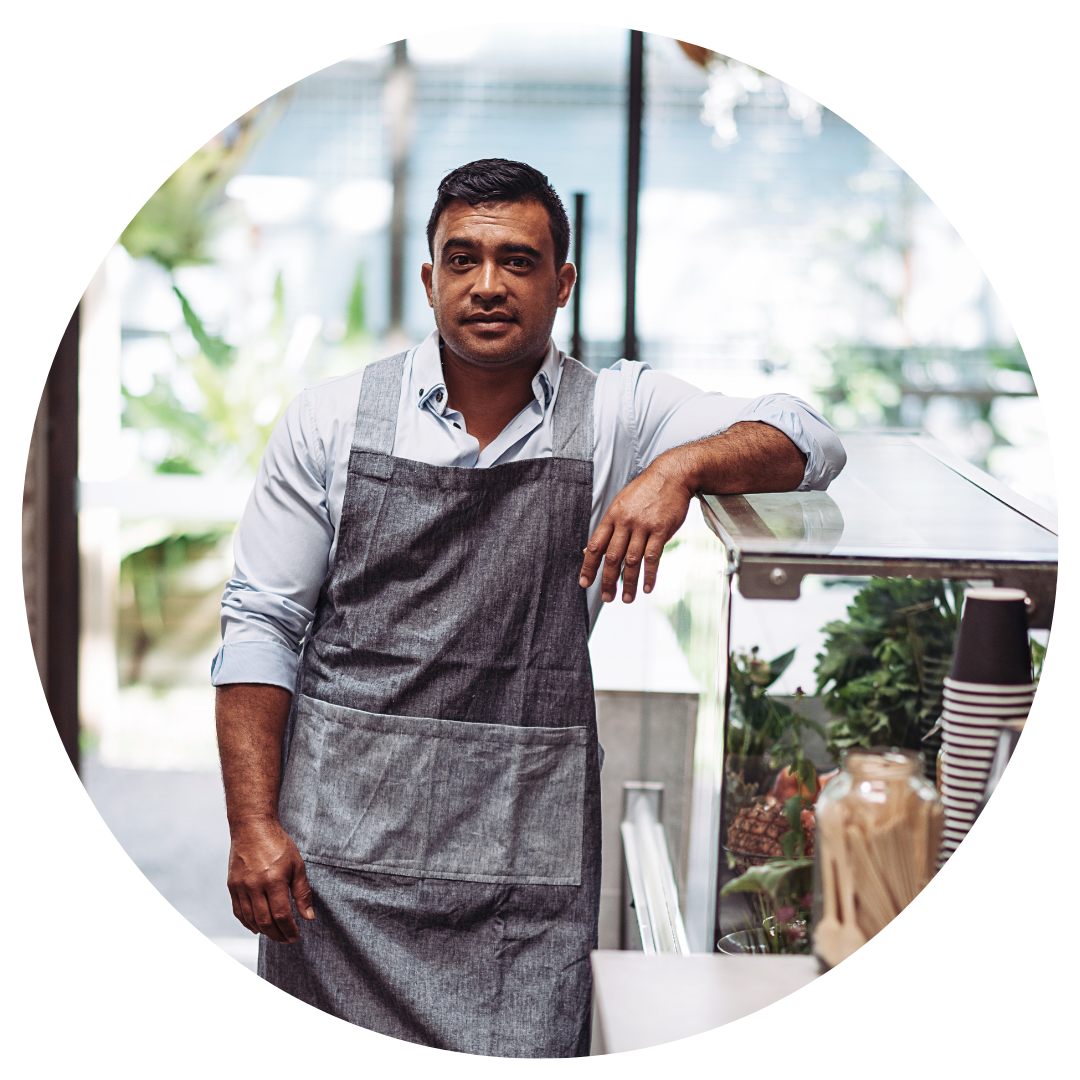 shop owner standing next to counter 