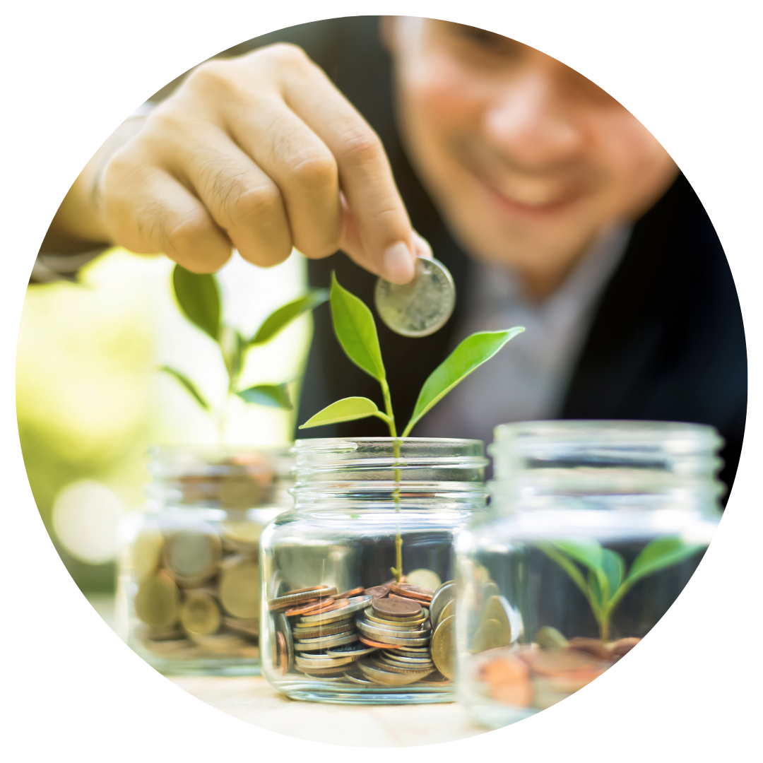 person putting coins into glass jars with plant saplings