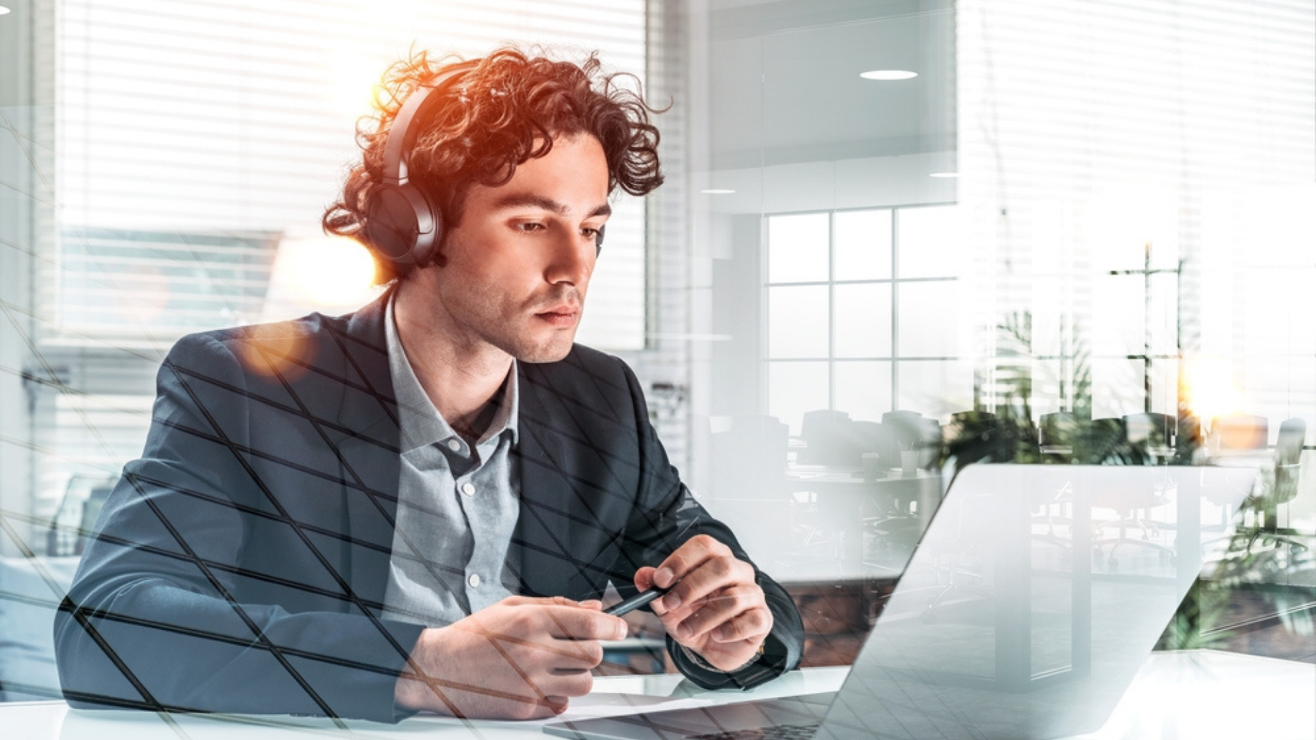 millennial man working on NFTs on a laptop-1