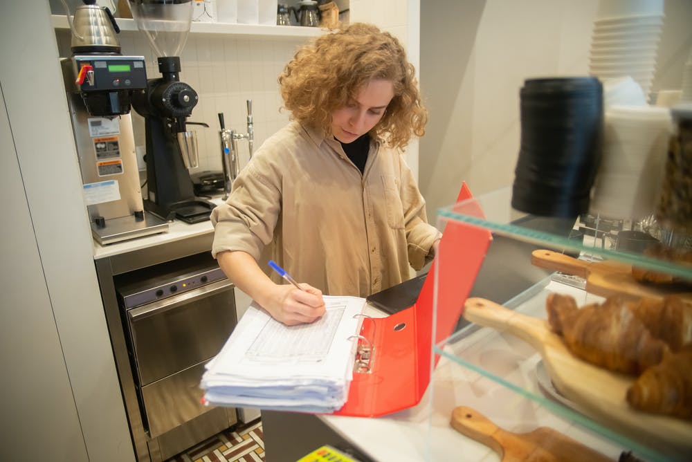 Woman taking restaurant inventory