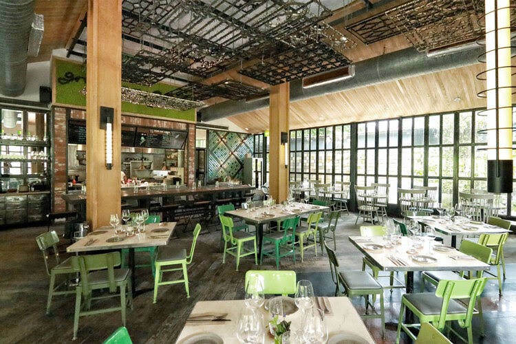 Greenhouse dining area of Open Farm Community.